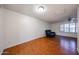 Cozy living room featuring wood-look floors, ceiling fan, and a comfortable leather recliner at 4718 W El Caminito Dr, Glendale, AZ 85302
