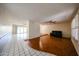 Open living room with hardwood floors and a ceiling fan for comfortable living at 4718 W El Caminito Dr, Glendale, AZ 85302