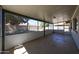 Enclosed, screened-in patio with concrete flooring, offering a pleasant outdoor living space at 4718 W El Caminito Dr, Glendale, AZ 85302