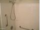 Shower with white tile and stainless steel safety bars at 4718 W El Caminito Dr, Glendale, AZ 85302