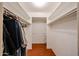 Walk-in closet with hardwood floors and shelving and hanging space for ample storage at 4718 W El Caminito Dr, Glendale, AZ 85302