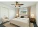 Bright bedroom features neutral decor, a ceiling fan, and ample natural light from the window at 7436 E Chaparral Rd # 159B, Scottsdale, AZ 85250