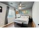 Cozy bedroom with wood floors, neutral walls, a ceiling fan and natural light from the window at 10010 N 64Th Ave, Glendale, AZ 85302
