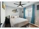 Cozy bedroom with a ceiling fan, wood floors, and natural light from the window at 10010 N 64Th Ave, Glendale, AZ 85302
