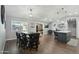 Open dining area with sleek black table and chairs, flowing into the kitchen space at 10010 N 64Th Ave, Glendale, AZ 85302