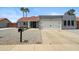 Charming single-story home featuring desert landscaping, a red-tiled roof, and a two-car garage at 10010 N 64Th Ave, Glendale, AZ 85302