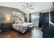 Stylish main bedroom showcasing a comfortable bed, wood-look flooring, and plenty of natural light at 10010 N 64Th Ave, Glendale, AZ 85302