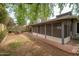 Backyard featuring a screened-in porch, brick accents, and lush greenery at 1014 W Hononegh Dr, Phoenix, AZ 85027