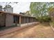 A serene backyard with a screened-in patio, lush trees, and a well-maintained lawn at 1014 W Hononegh Dr, Phoenix, AZ 85027