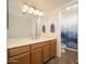 Bathroom features wood cabinetry, and a shower and tub combo at 1014 W Hononegh Dr, Phoenix, AZ 85027
