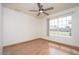 Bedroom features wood flooring, a ceiling fan, and a large window at 1014 W Hononegh Dr, Phoenix, AZ 85027