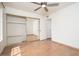Bedroom with hardwood floors, ceiling fan, and mirrored closet doors at 1014 W Hononegh Dr, Phoenix, AZ 85027
