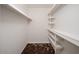 Walk in closet features shelving and decorative carpet at 1014 W Hononegh Dr, Phoenix, AZ 85027