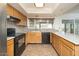 This kitchen features granite countertops, stainless steel appliances, and wood cabinetry at 1014 W Hononegh Dr, Phoenix, AZ 85027