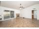 Open-concept living space boasts a brick fireplace, sliding glass doors, and tile floors at 1014 W Hononegh Dr, Phoenix, AZ 85027