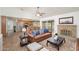 Inviting living room featuring an open floor plan with kitchen, a fireplace, and a cozy leather sofa at 1014 W Hononegh Dr, Phoenix, AZ 85027