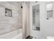 Bright bathroom showcasing tile shower, glass shelving, and full length mirror at 1025 E Northern Ave, Phoenix, AZ 85020