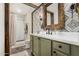 Bathroom showcasing custom tile, painted cabinets, quartz countertop and ornate mirror at 1025 E Northern Ave, Phoenix, AZ 85020