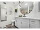 Modern bathroom features a round mirror, white vanity with gold hardware, and sleek fixtures at 1025 E Northern Ave, Phoenix, AZ 85020