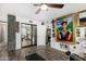 Spacious bonus room with a ceiling fan, mirrored closet doors, and decorative artwork at 1025 E Northern Ave, Phoenix, AZ 85020