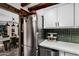 Modern kitchen featuring stainless steel refrigerator and dishwasher with white upper cabinets at 1025 E Northern Ave, Phoenix, AZ 85020