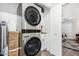 Laundry room featuring a stacked washer and dryer, custom storage and access to another room at 1025 E Northern Ave, Phoenix, AZ 85020