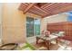 Cozy back patio featuring a wood pergola, textured wall, and outdoor seating, ideal for relaxation at 1025 E Northern Ave, Phoenix, AZ 85020