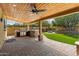 Backyard features a built-in BBQ, fire pit, and well-manicured lawn at 10896 N 105Th Way, Scottsdale, AZ 85259