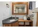 Charming bathroom boasts a wood framed mirror, stone counters, and attractive decor at 10896 N 105Th Way, Scottsdale, AZ 85259