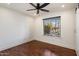 Bright bedroom boasts a modern ceiling fan, dark-stained hardwood floors, and plenty of natural light at 10896 N 105Th Way, Scottsdale, AZ 85259