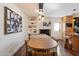 Dining area with a modern light fixture, built-in shelving, and an adjacent fireplace at 10896 N 105Th Way, Scottsdale, AZ 85259