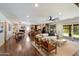 Bright open-concept living room with hardwood floors, and seamless flow to a modern kitchen and outdoor patio at 10896 N 105Th Way, Scottsdale, AZ 85259