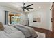Comfortable main bedroom with backyard pool views, a ceiling fan, and neutral decor at 10896 N 105Th Way, Scottsdale, AZ 85259