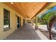 Spacious covered patio features brick pavers, wood ceilings, and backyard access to a large outdoor space at 10896 N 105Th Way, Scottsdale, AZ 85259