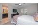 Bedroom with ensuite bathroom, a large window, and a comfortable bed at 1216 E Ormondo Way, Phoenix, AZ 85014