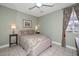 Cozy bedroom with neutral walls, ceiling fan, and two side table lamps at 1216 E Ormondo Way, Phoenix, AZ 85014