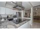 Modern kitchen with stainless steel appliances, granite countertops, and a stylish overhead vent at 1216 E Ormondo Way, Phoenix, AZ 85014