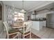 Eat in kitchen with stainless appliances, tile floors, and a view to an outdoor seating area at 1216 E Ormondo Way, Phoenix, AZ 85014