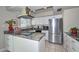 Bright kitchen features stainless appliances, white cabinets, and modern countertops at 1216 E Ormondo Way, Phoenix, AZ 85014