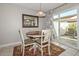 Kitchen dining area with decorative rug, pendant light, and sliding doors to the outdoor patio at 1216 E Ormondo Way, Phoenix, AZ 85014