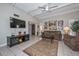 Open concept living room with fireplace, sofa, and mounted television at 1216 E Ormondo Way, Phoenix, AZ 85014