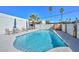 Community pool surrounded by lounge chairs and palm trees under a blue sky at 1216 E Ormondo Way, Phoenix, AZ 85014