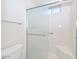 Bright bathroom with a shower featuring a sliding glass door and safety bars at 1216 E Ormondo Way, Phoenix, AZ 85014