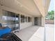 Spacious covered patio with a grill and easy access to the outdoor pool and lounge areas at 14703 W Hillside St, Goodyear, AZ 85395