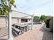 Backyard featuring a pergola covered picnic table with pool and lush landscaping in the background at 14703 W Hillside St, Goodyear, AZ 85395