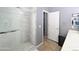 Bathroom featuring a spacious shower with glass door, vanity, and storage, creating a modern and accessible design at 14703 W Hillside St, Goodyear, AZ 85395
