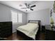 Bedroom features a ceiling fan, window with plantation shutters, and dark furnishings, providing a tranquil retreat at 14703 W Hillside St, Goodyear, AZ 85395