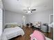 This bedroom has wood floors, a ceiling fan, and a bright, neutral color palette at 14703 W Hillside St, Goodyear, AZ 85395