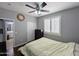 Bedroom features a ceiling fan, closet, and access to the en suite bathroom, enhancing everyday living at 14703 W Hillside St, Goodyear, AZ 85395