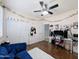 Bright bedroom featuring a cozy blue sofa, plush rug, and laminate wood flooring at 14703 W Hillside St, Goodyear, AZ 85395